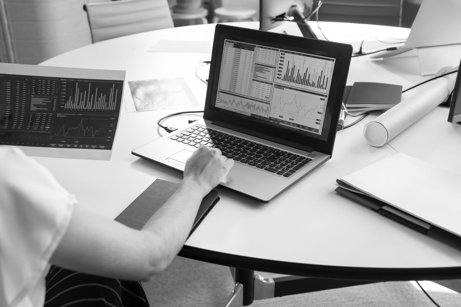 Small business owner comparing SEO tool dashboards while planning a content calendar for the year